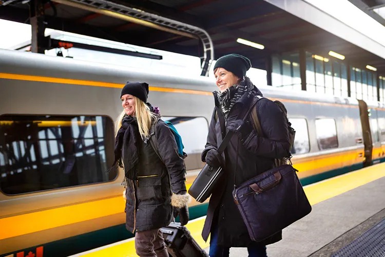 Two people boarding via rail train.