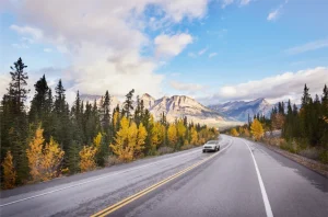 Car travelling along the Icefield Parkway during fall