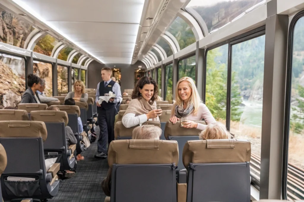 Passenger aboard the Rocky Mountaineer Silverleaf, enjoying their train ride and chatting.