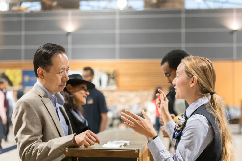 Rocky Mountaineer customers checking in for their train journey, with luggage being handled.