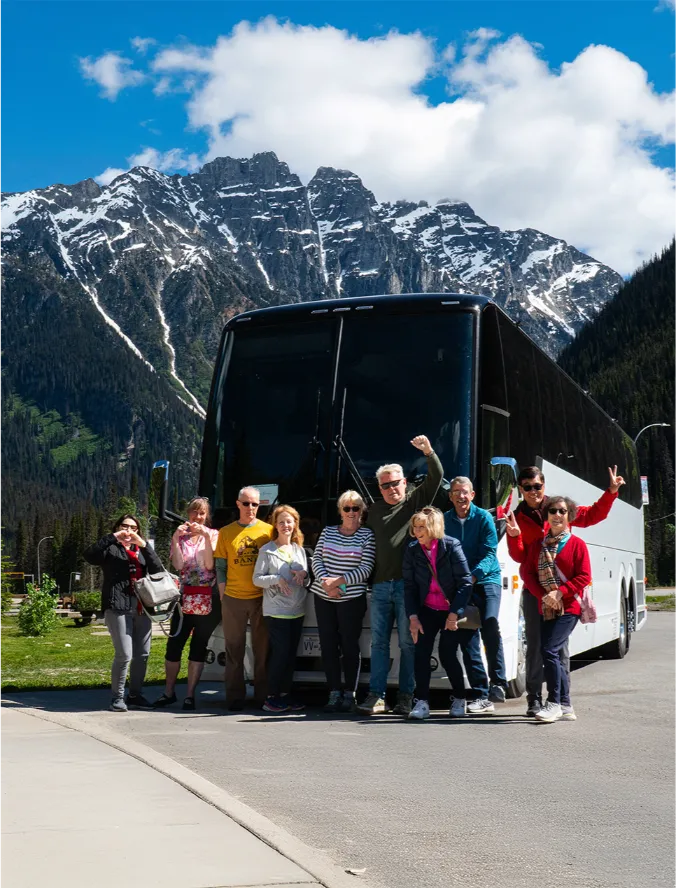 a group of people standing in front of a bus